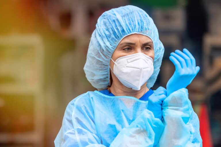 Nurse putting on gloves