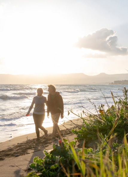 Couple walking on beach in Delta