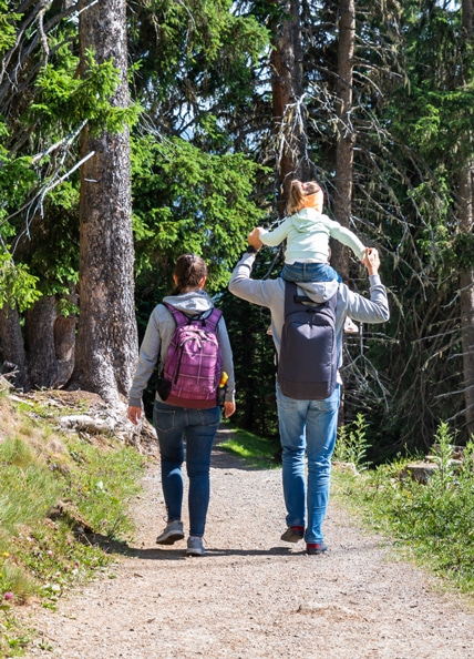 Couple hiking on trail with chnild