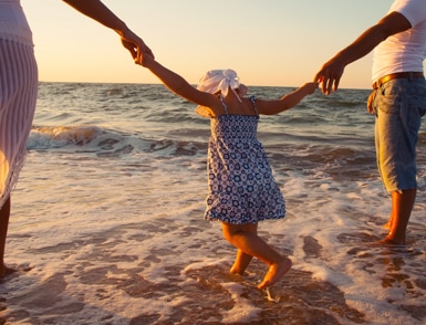 Family walking on beach