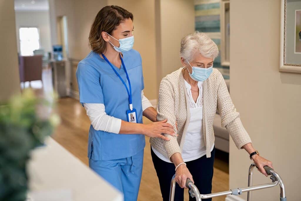 Nurse walking older patient