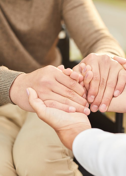 Patient holding hands with social worker