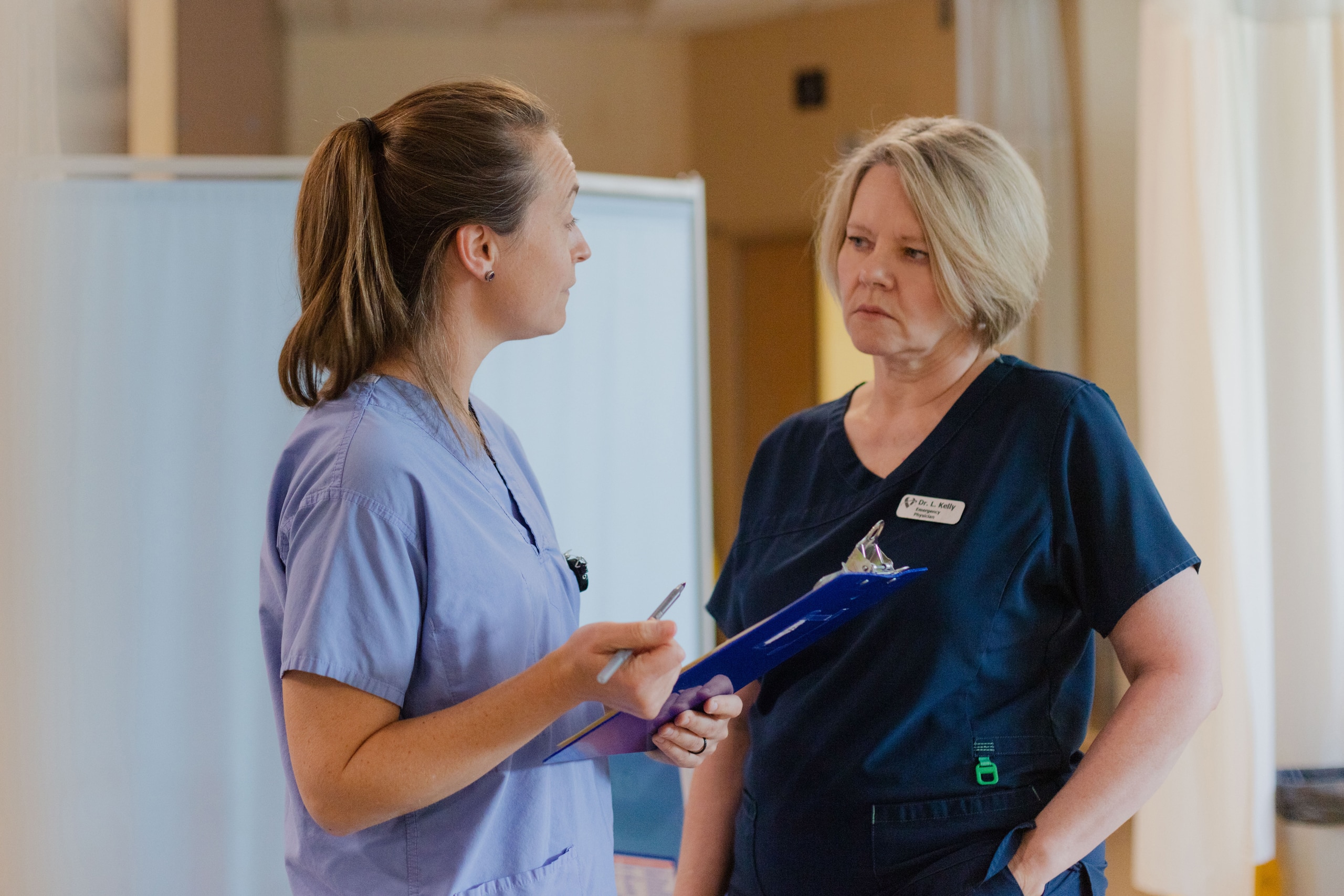 Emergency physician discussing treatment plan with nurse