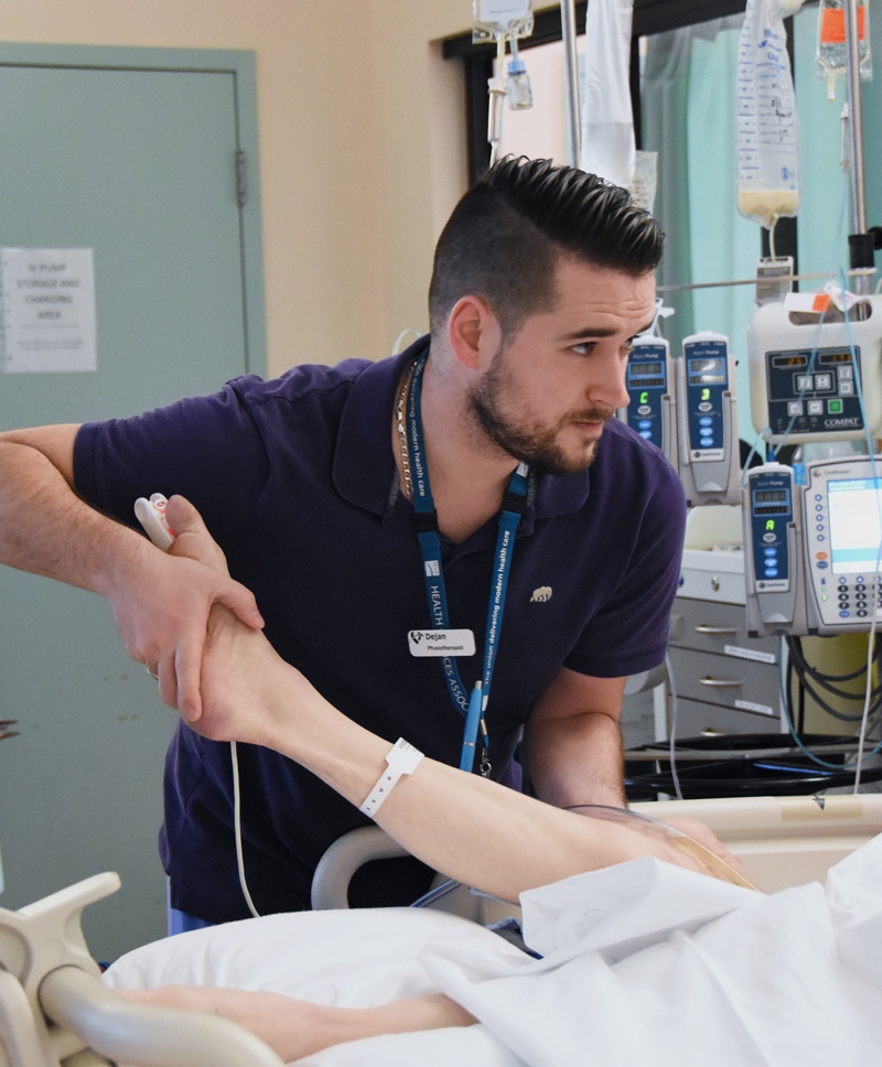 A Fraser Health physiotherapist helping a patient at an acute site.