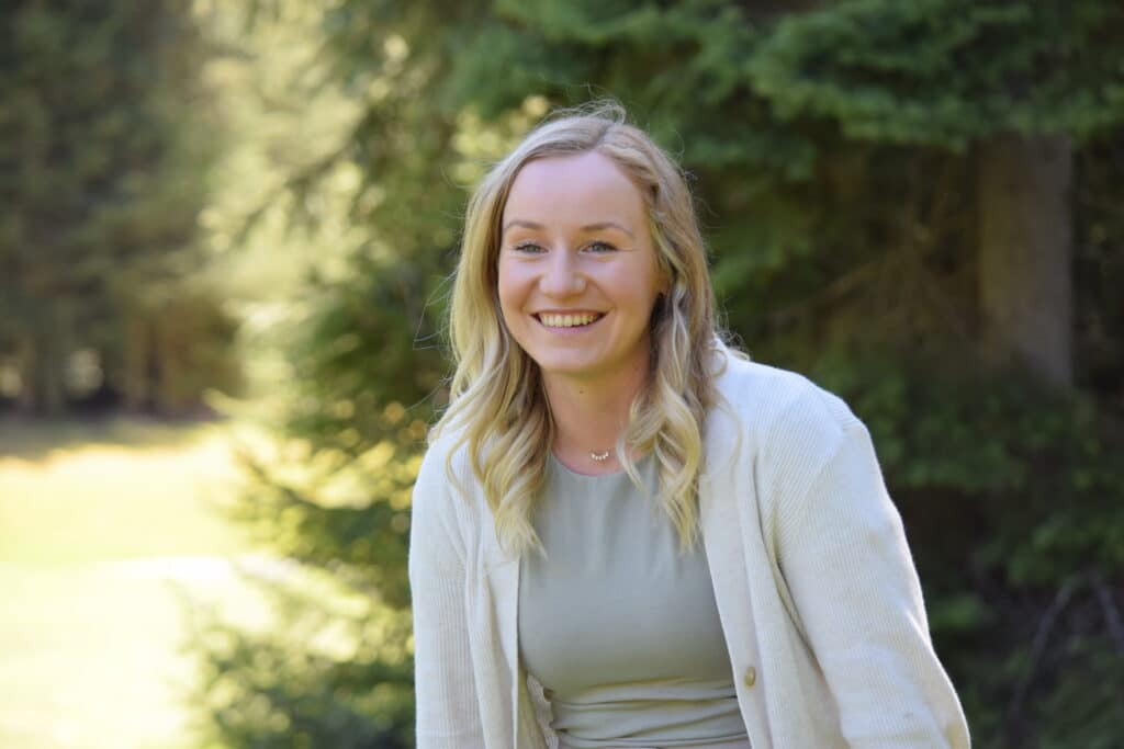 MHSU Project Planning Leader smiling in the a bright forest background