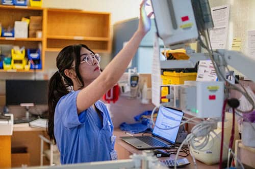 nurse working with medical equipment
