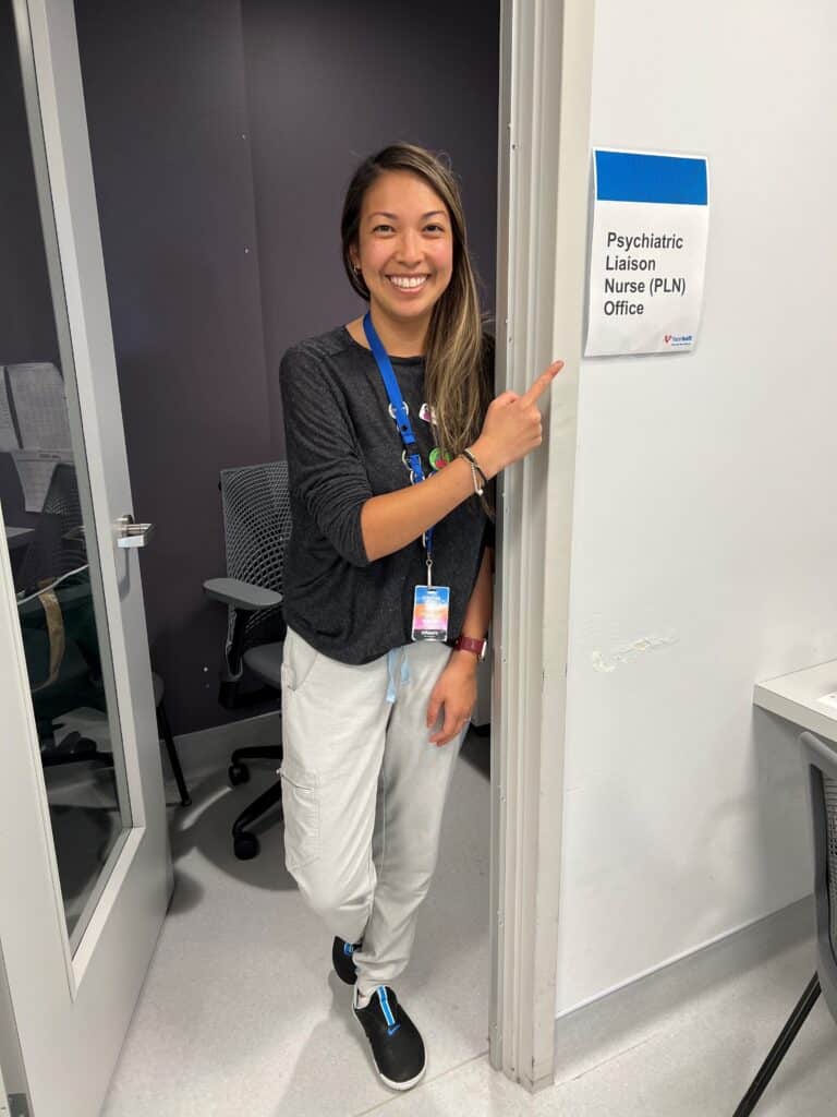 Nurse pointing at a sign
