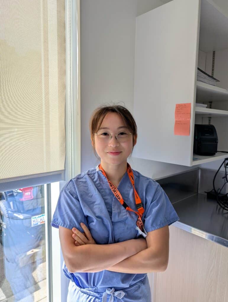 Ultrasound & Echo technician in scrubs smiling