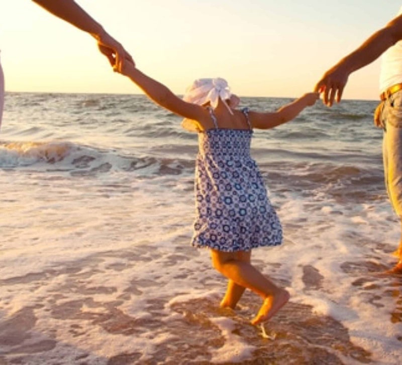 Family at beach with toddler.