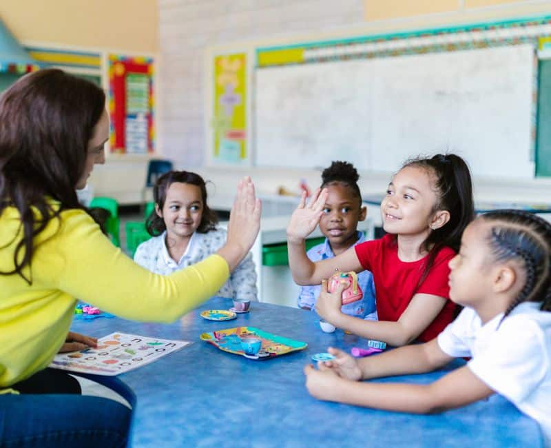 Kids in school with their teacher,