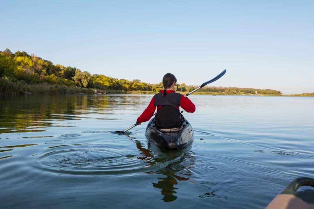 Woman kayaking on a sunny day.