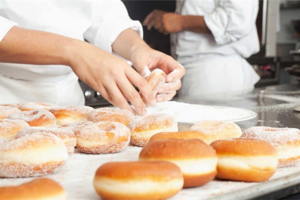 Baker making doughnuts.