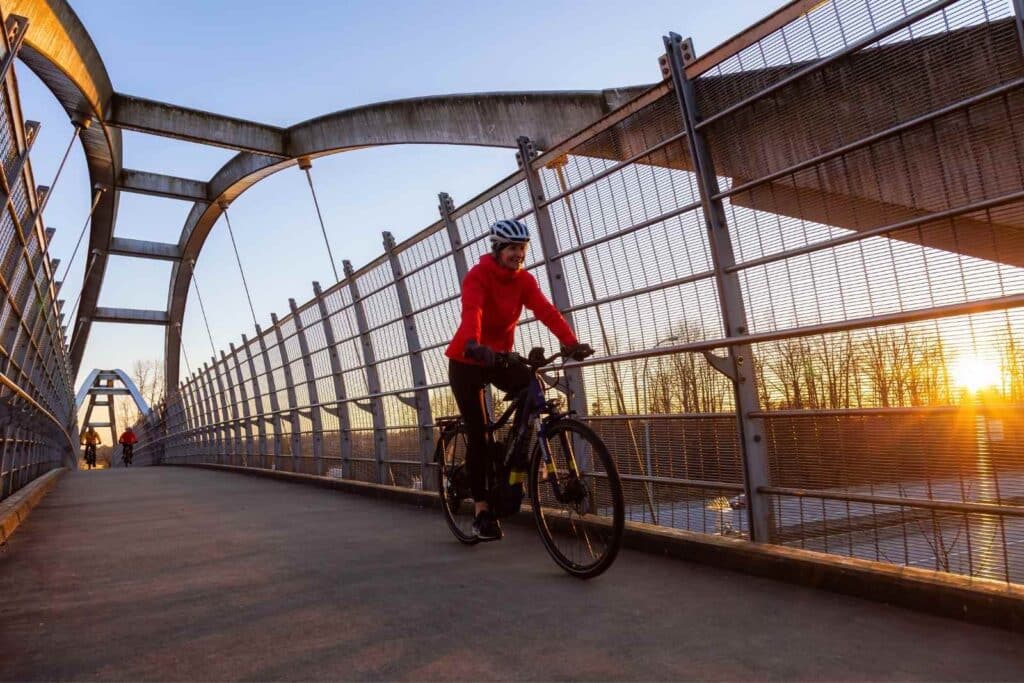 Cyclist crossing bridge in Surrey.