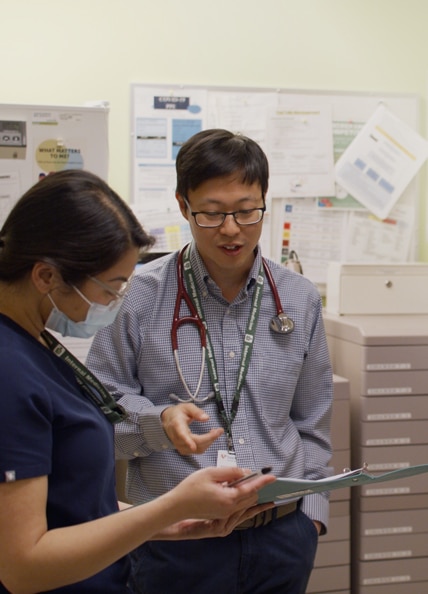 Physician looking at chart.