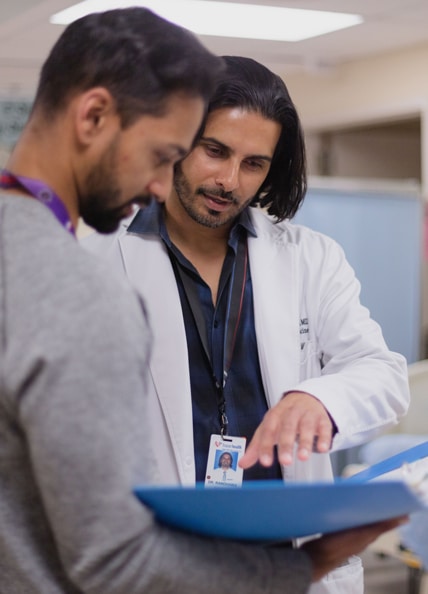 Physician looking at chart.