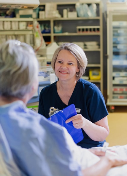Physician looking at chart with patient.