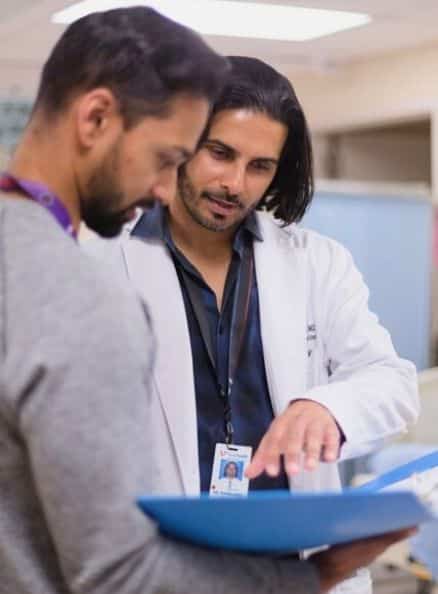 Physician looking at chart.