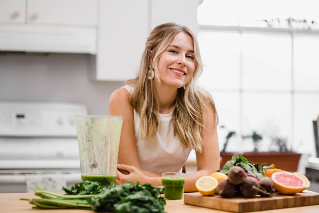 Clinical dietitian standing making a green smoothie